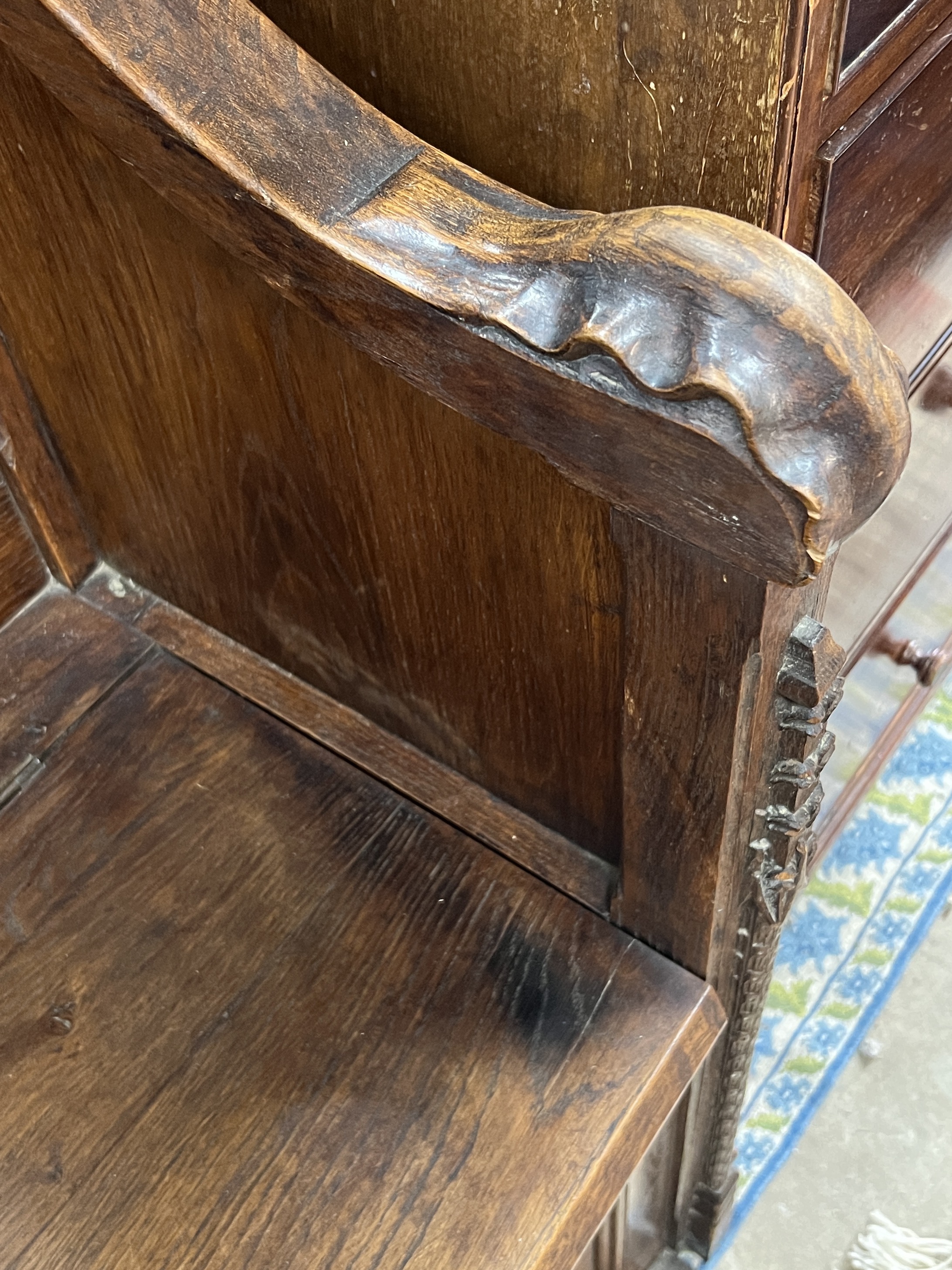 An early 20th century carved oak Gothic Revival settle with hinged box seat, width 137cm, depth 49cm, height 160cm